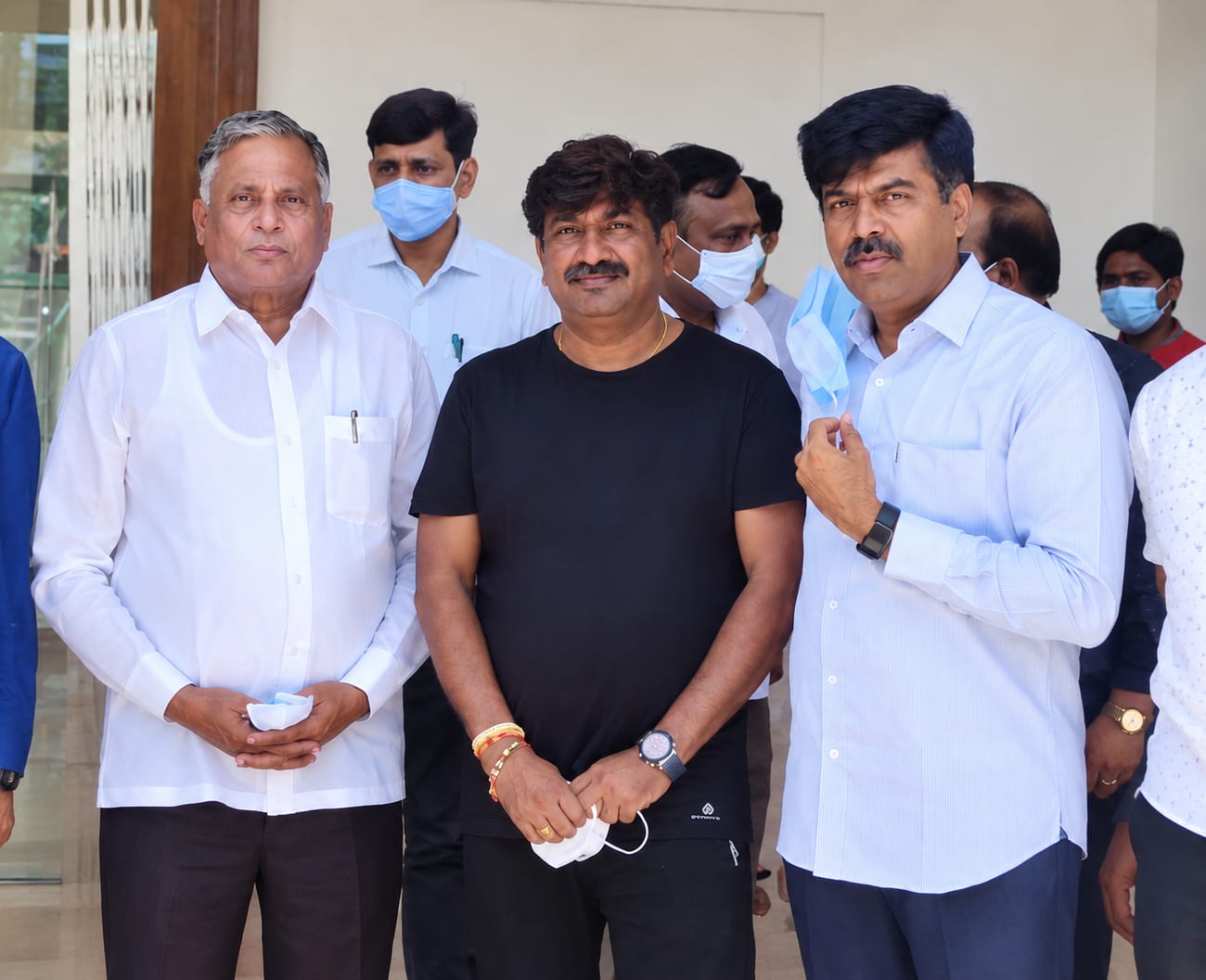 Ramesh BV with members of his community at a building entrance